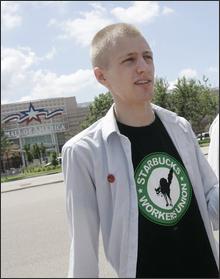 In this July 22, 2008 file photo, Erik Forman, a former Starbucks employee at the Mall of America who claims he was fired for union organizing, addresses the media across from the mall in Bloomington, Minn. Forman has been given his job back and will return to work Sunday, Aug. 31, 2008. (AP Photo/Jim Mone, file)